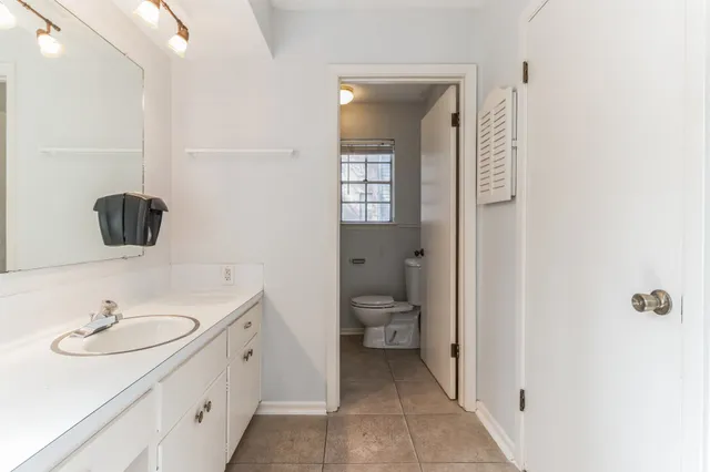 a white toilet sitting next to a bathroom sink