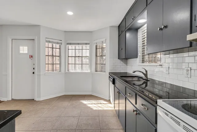 a kitchen with stainless steel appliances a refrigerator and a sink