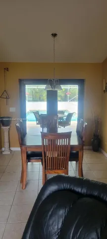 a dining room with furniture and window