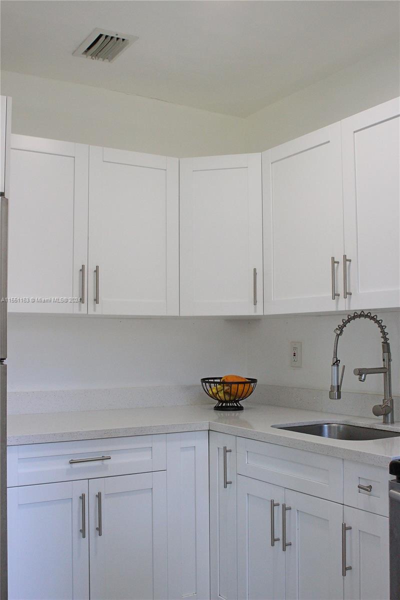 Gladeview Miami, FL 33147 - Photo 12 of 25 a kitchen with white cabinets and a sink