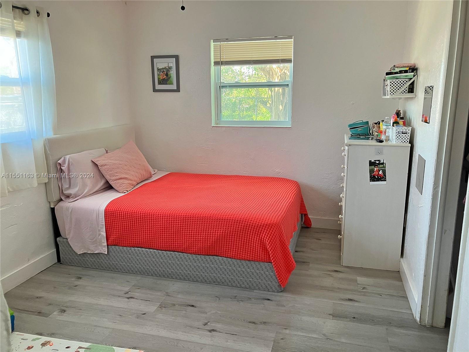 Gladeview Miami, FL 33147 - Photo 16 of 25 a bedroom with a bed and a window