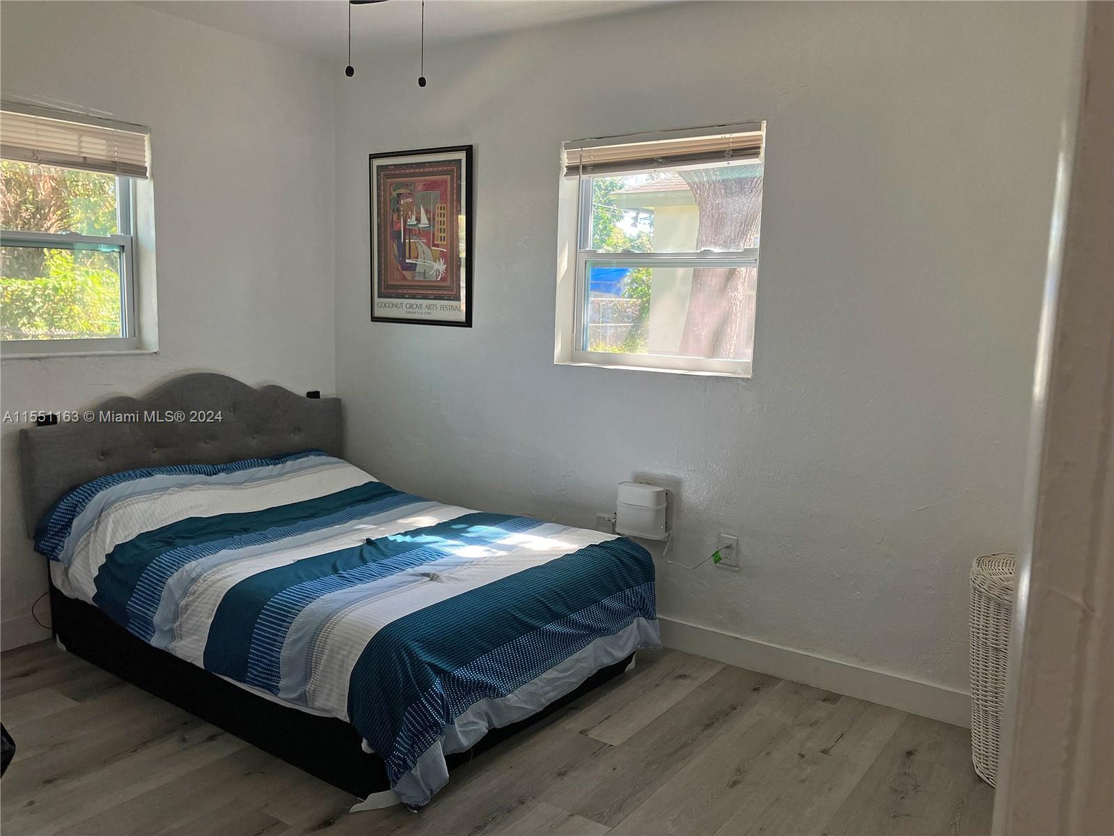 Gladeview Miami, FL 33147 - Photo 17 of 25 a bedroom with a bed and window