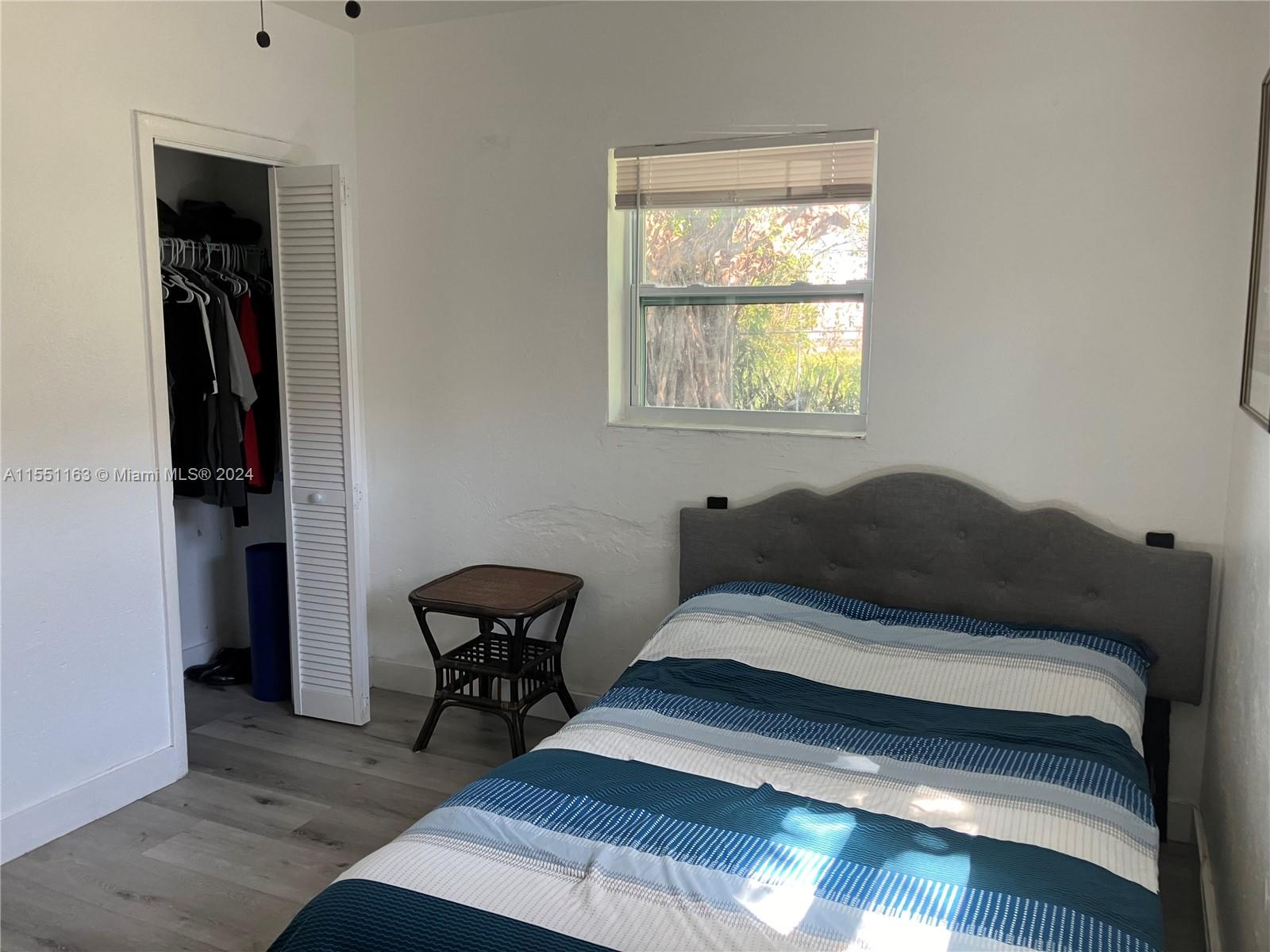 Gladeview Miami, FL 33147 - Photo 18 of 25 a bedroom with a bed and a window