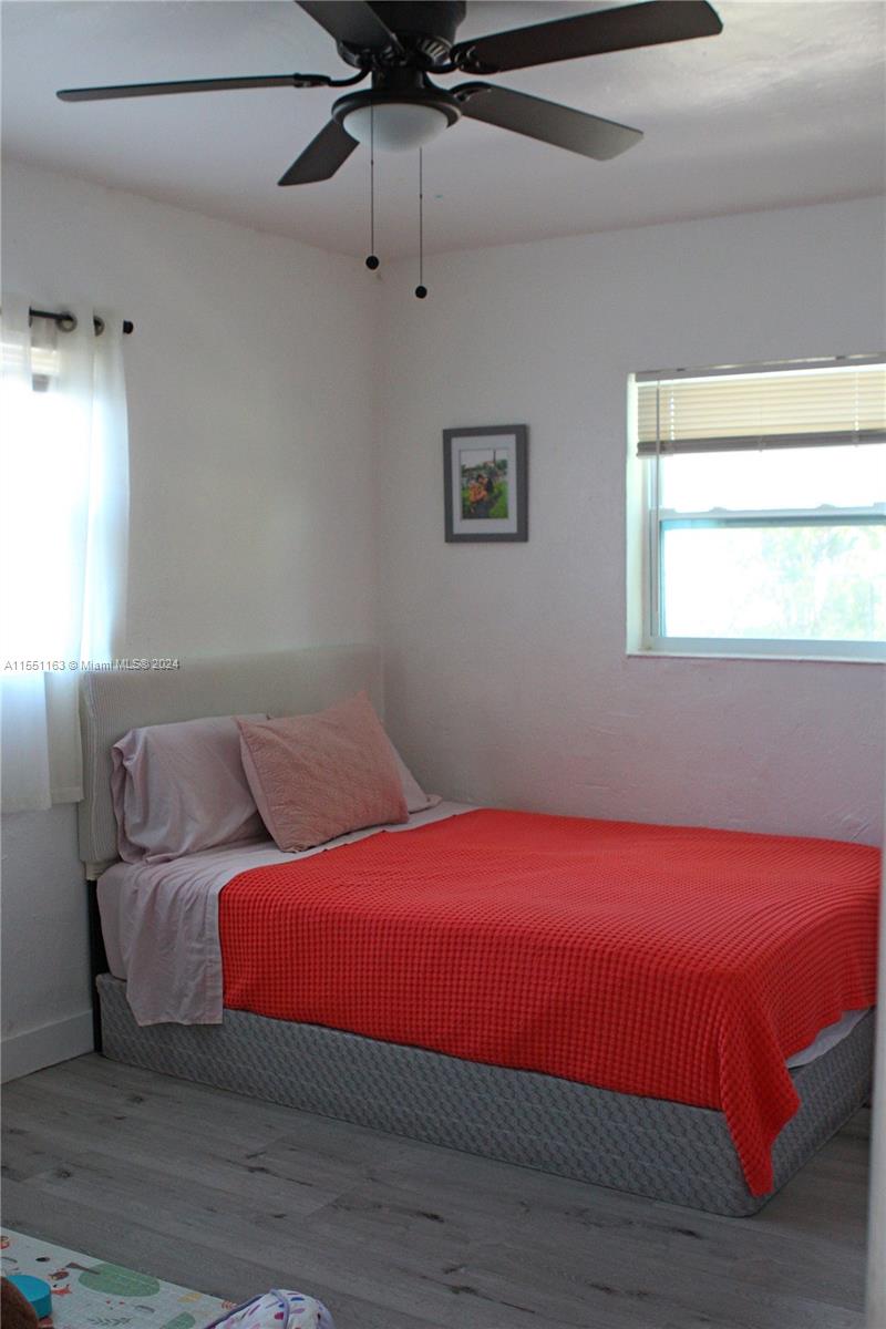 Gladeview Miami, FL 33147 - Photo 19 of 25 a bedroom with a bed and a window