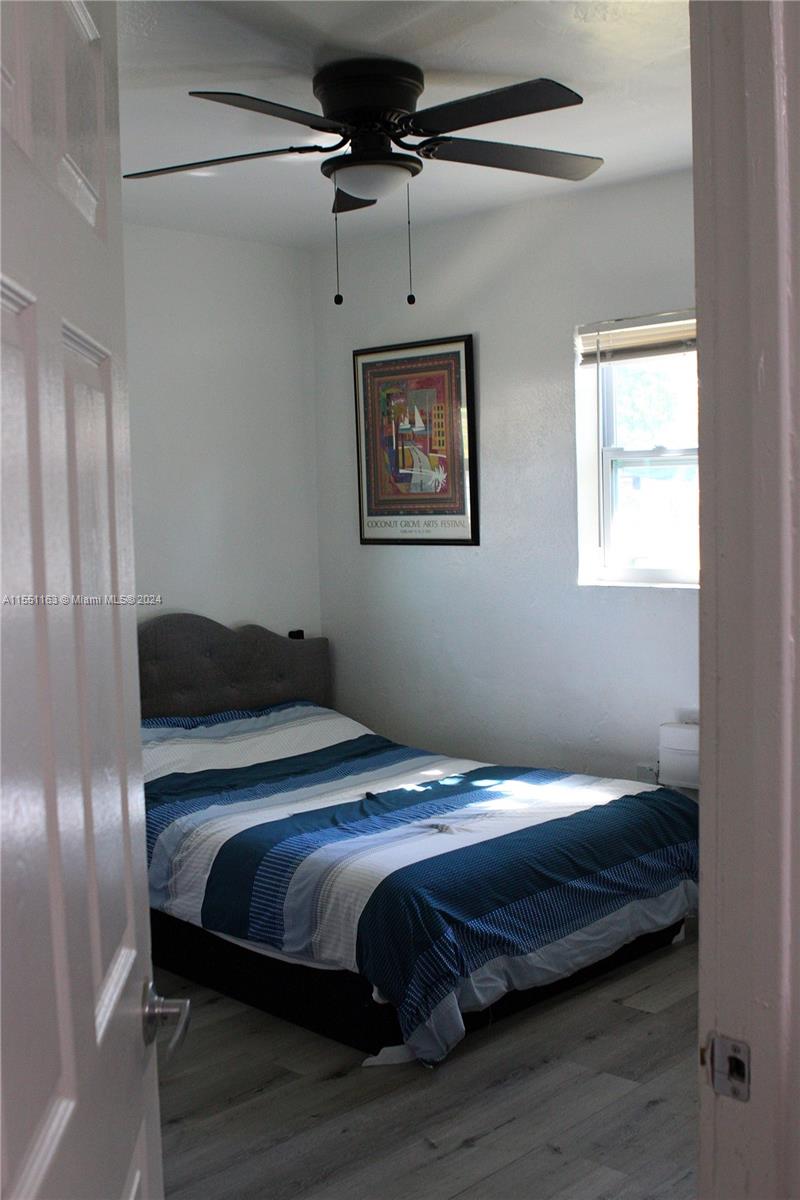 Gladeview Miami, FL 33147 - Photo 20 of 25 a bedroom with a bed and wooden floor