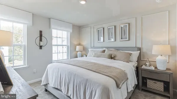 a bedroom with a bed a mirror and a window