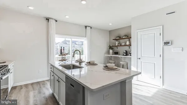 a kitchen with granite countertop a sink and cabinets