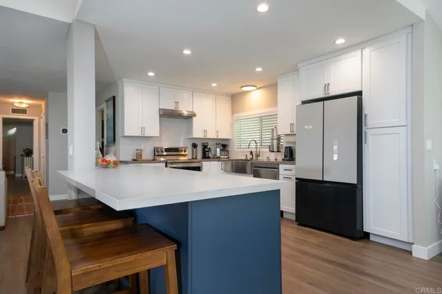 a kitchen with refrigerator and cabinets