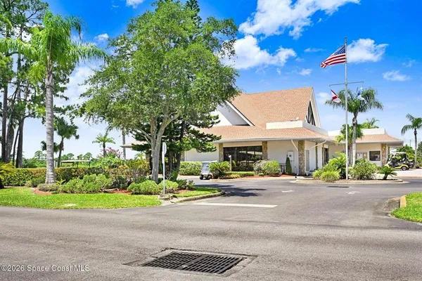 a row of palm trees in front of house