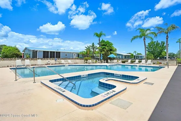 a view of a swimming pool with an outdoor seating