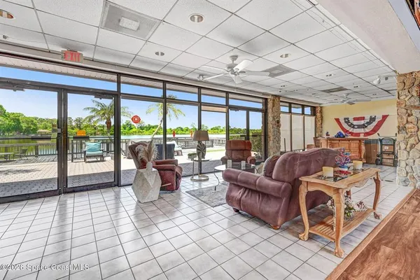 a living room with furniture a flat screen tv and a table