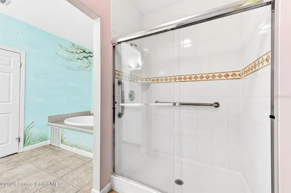 a bathroom with a glass shower door