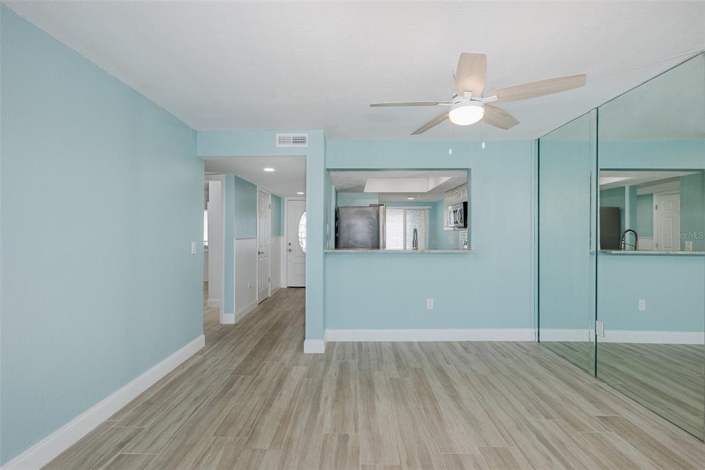 8150 Brent Street, Unit 742 Port Richey, FL 34668 - Photo 13 of 51 a view of wooden floor and windows in a room