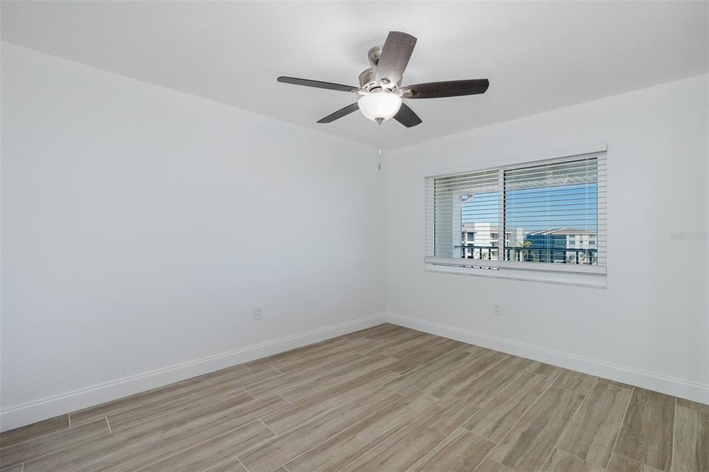 8150 Brent Street, Unit 742 Port Richey, FL 34668 - Photo 15 of 51 a view of empty room with wooden floor and fan