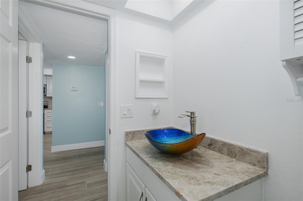 8150 Brent Street, Unit 742 Port Richey, FL 34668 - Photo 19 of 51 a bathroom with a granite countertop sink and a mirror