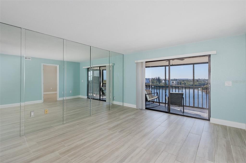 8150 Brent Street, Unit 742 Port Richey, FL 34668 - Photo 21 of 51 an empty room with wooden floor and windows