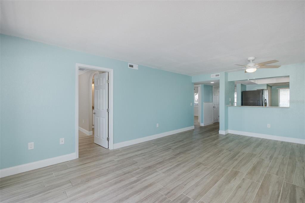 8150 Brent Street, Unit 742 Port Richey, FL 34668 - Photo 25 of 51 a view of an empty room with wooden floor and a window