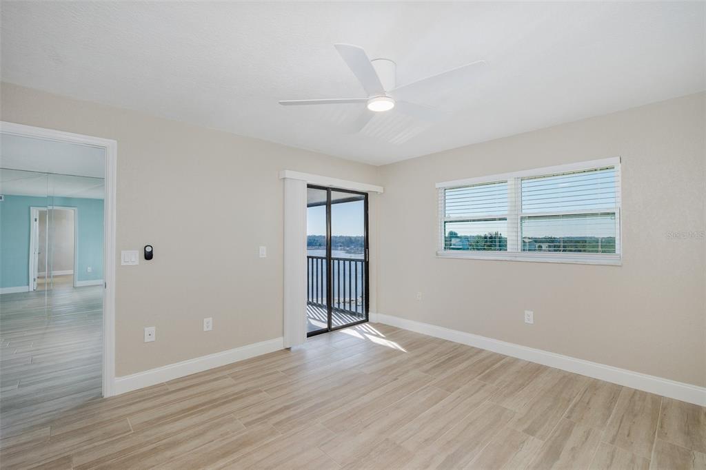 8150 Brent Street, Unit 742 Port Richey, FL 34668 - Photo 27 of 51 an empty room with wooden floor and windows