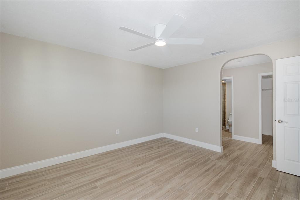 8150 Brent Street, Unit 742 Port Richey, FL 34668 - Photo 29 of 51 a view of a room with wooden floor and white walls