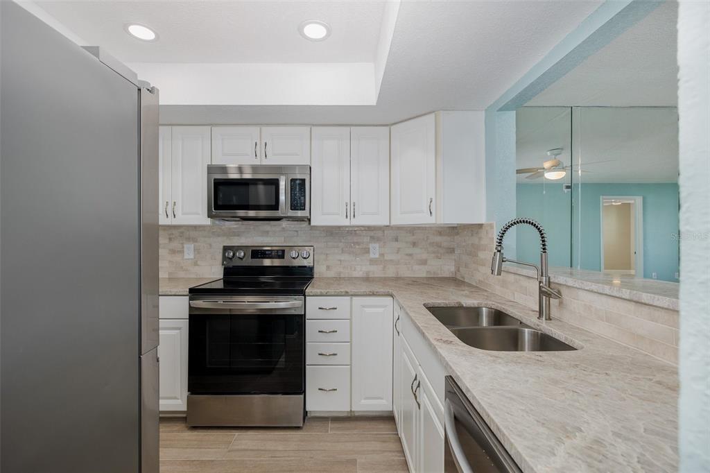 8150 Brent Street, Unit 742 Port Richey, FL 34668 - Photo 6 of 51 a kitchen with a sink stove and microwave