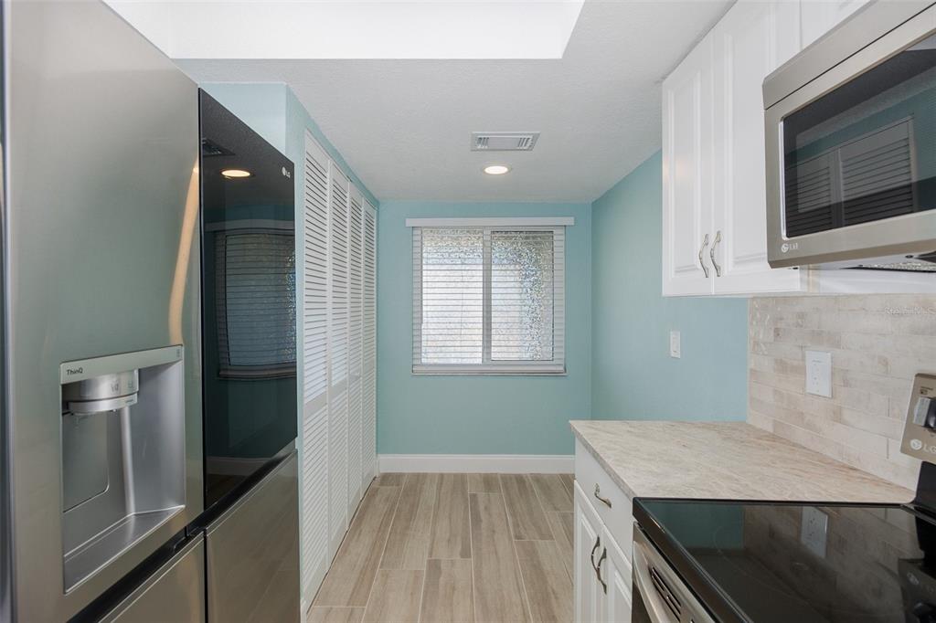8150 Brent Street, Unit 742 Port Richey, FL 34668 - Photo 8 of 51 a kitchen with a wooden floor and steel cabinets