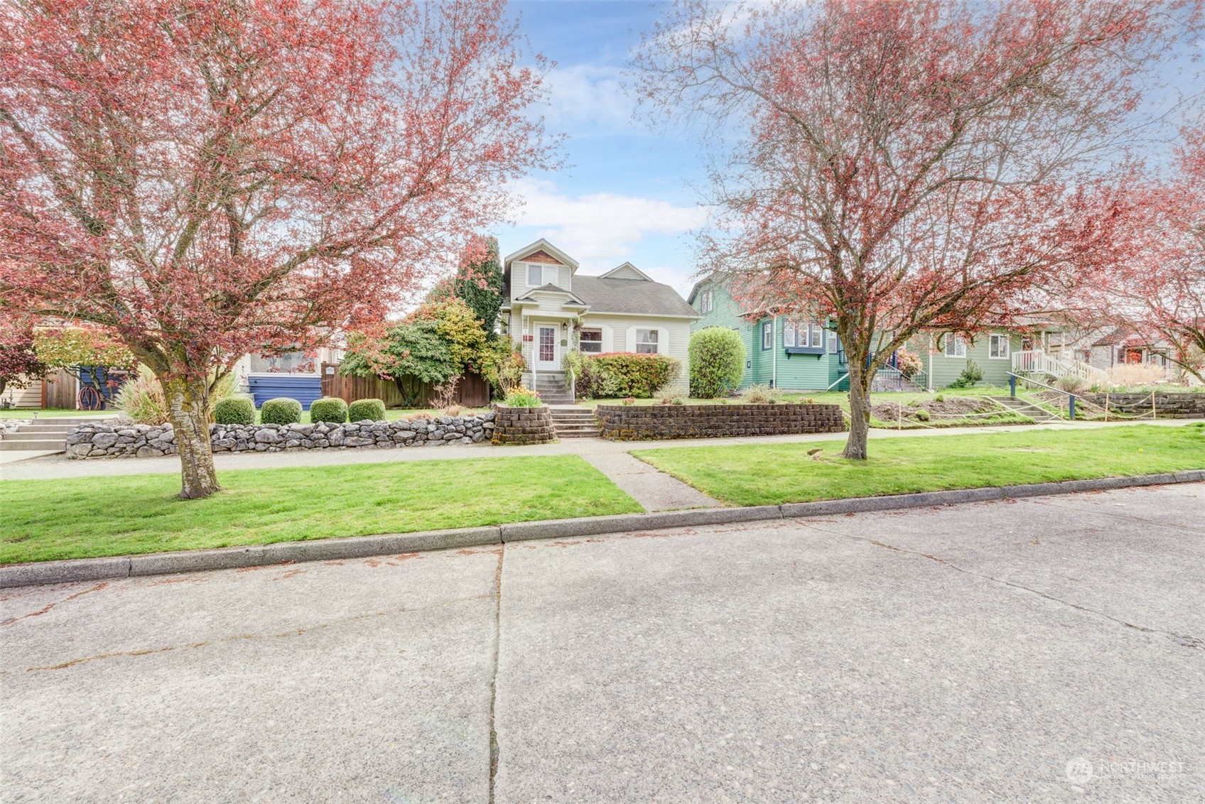 1709 Rainier Avenue Everett, WA 98201 - Photo 3 of 33 a view of a house with a big yard and large trees