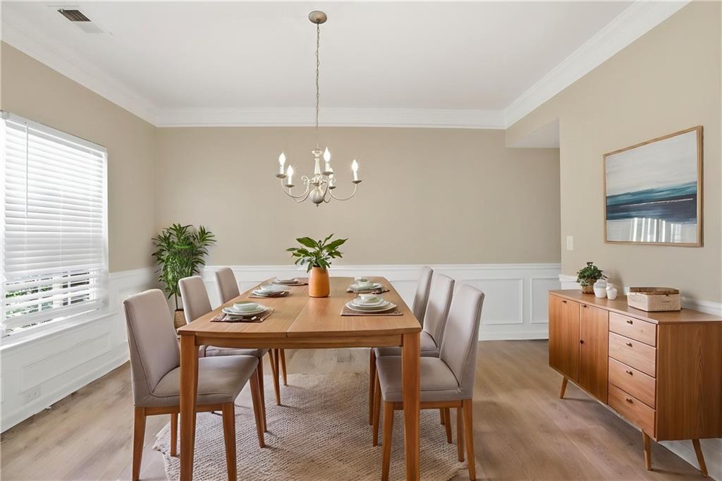 4968 Locherby Drive Fairburn, GA 30213 - Photo 3 of 39 a view of a dining room with furniture a chandelier and wooden floor