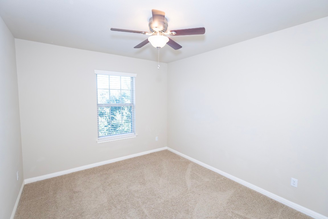 108 Mark Brooks Cove Round Rock, TX 78664 - Photo 17 of 24 an empty room with a window and a fan