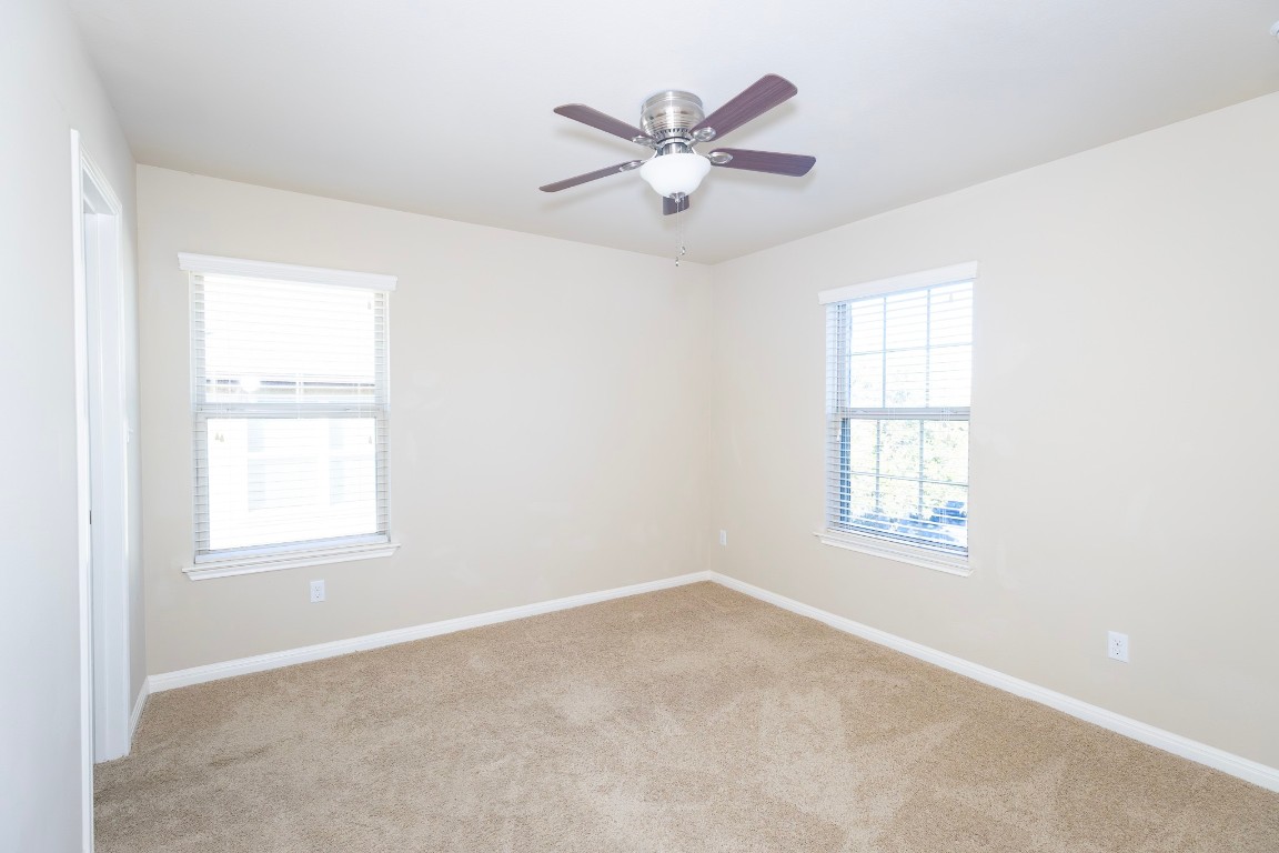 108 Mark Brooks Cove Round Rock, TX 78664 - Photo 19 of 24 an empty room with a window and a ceiling fan