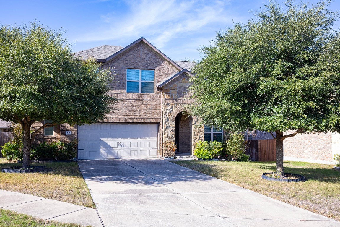 108 Mark Brooks Cove Round Rock, TX 78664 - Photo 3 of 24 a front view of a house with a yard and garage