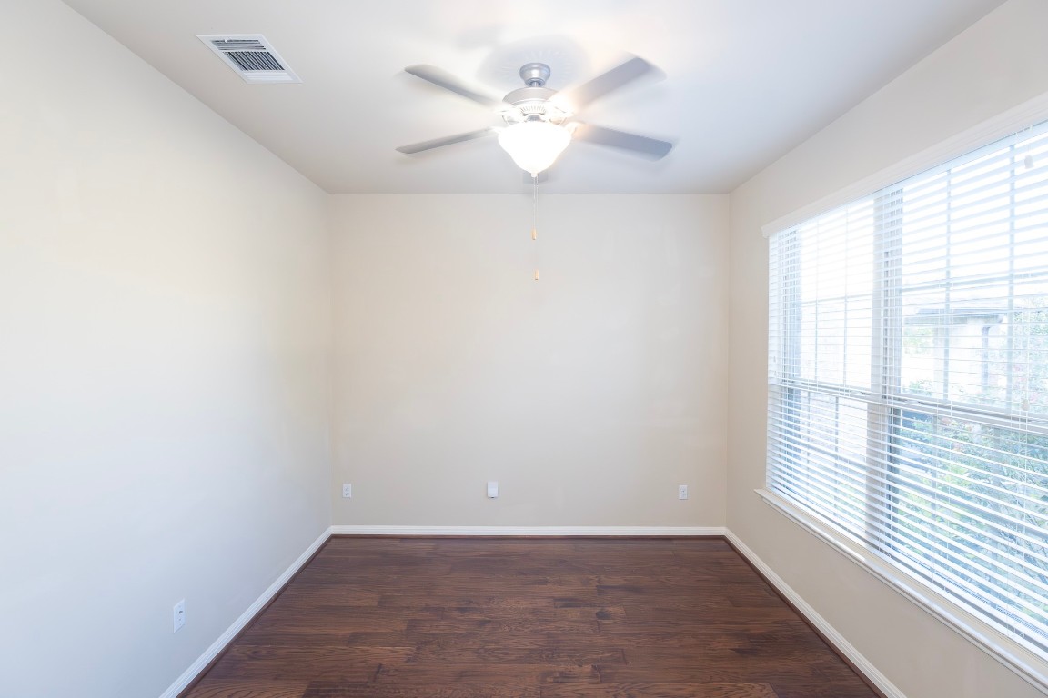 108 Mark Brooks Cove Round Rock, TX 78664 - Photo 4 of 24 wooden floor in an empty room with a window