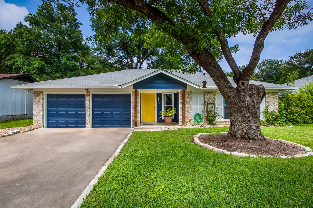 a front view of a house with a garden