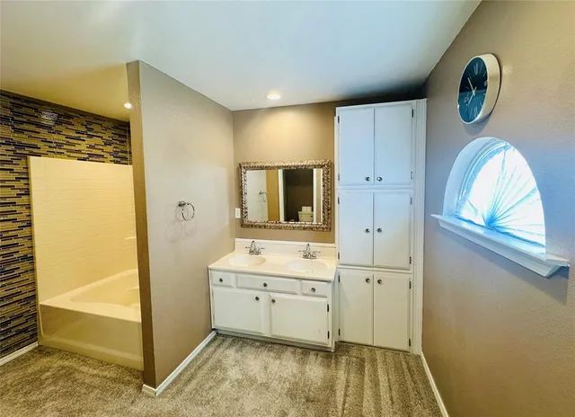 a view of bathroom with dual sinks