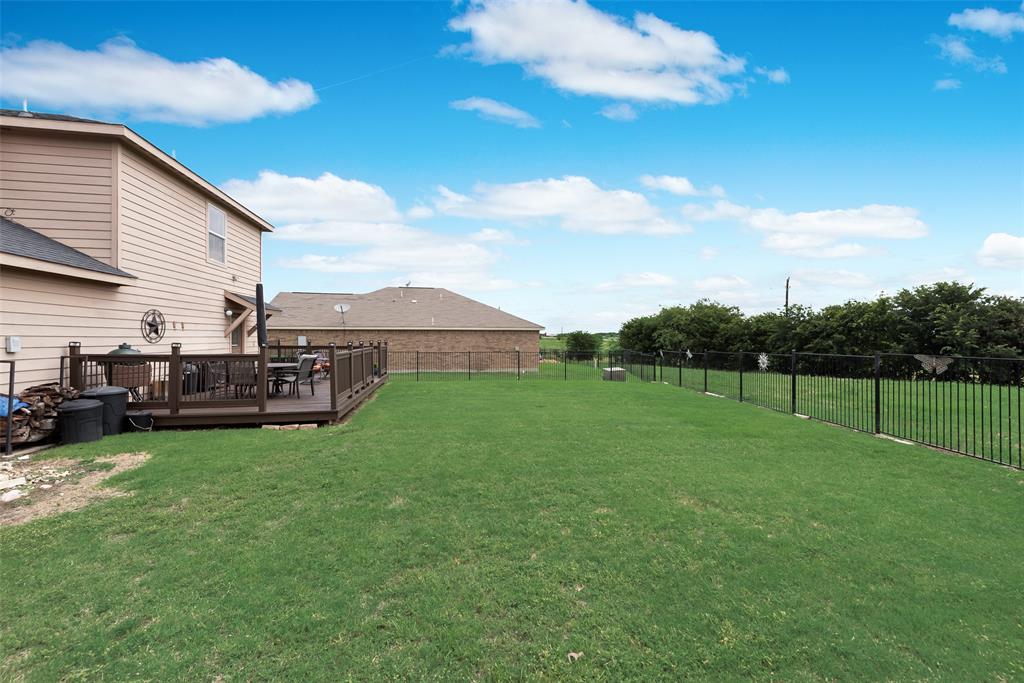 149 Cattlemans Creek Road Newark, TX 76071 - Photo 27 of 39 Large backyard with oversized deck and adjacent green belt at 149 Cattlemans Creek Rd in the Chisholm Springs neighborhood in Newark, TX 76071