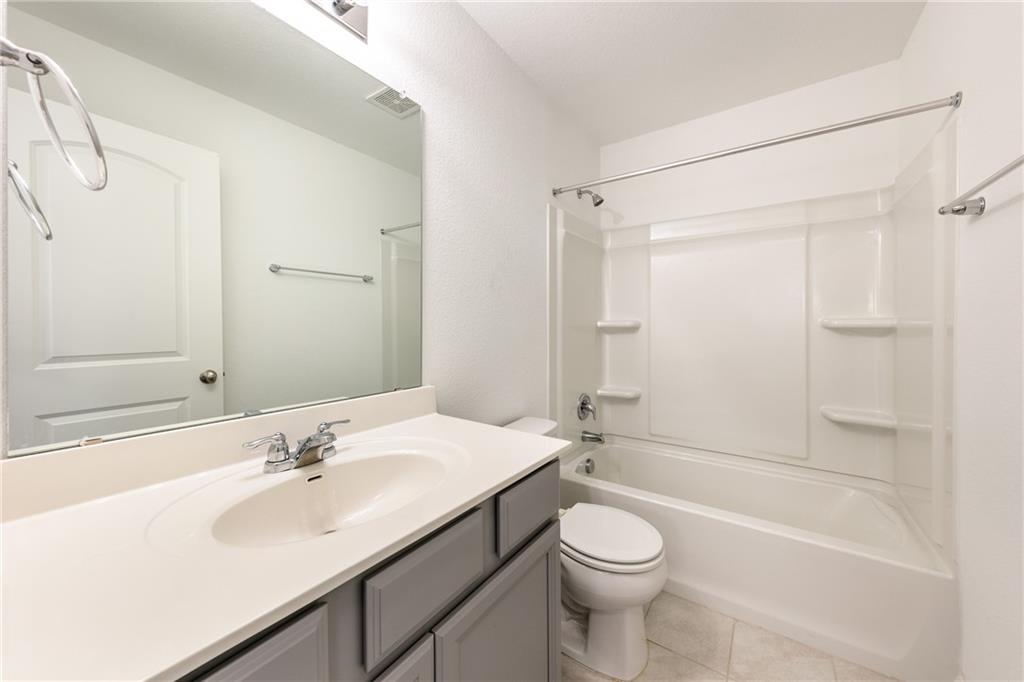 6708 Routenburn Street Austin, TX 78754 - Photo 11 of 21 a bathroom with a sink a toilet and shower