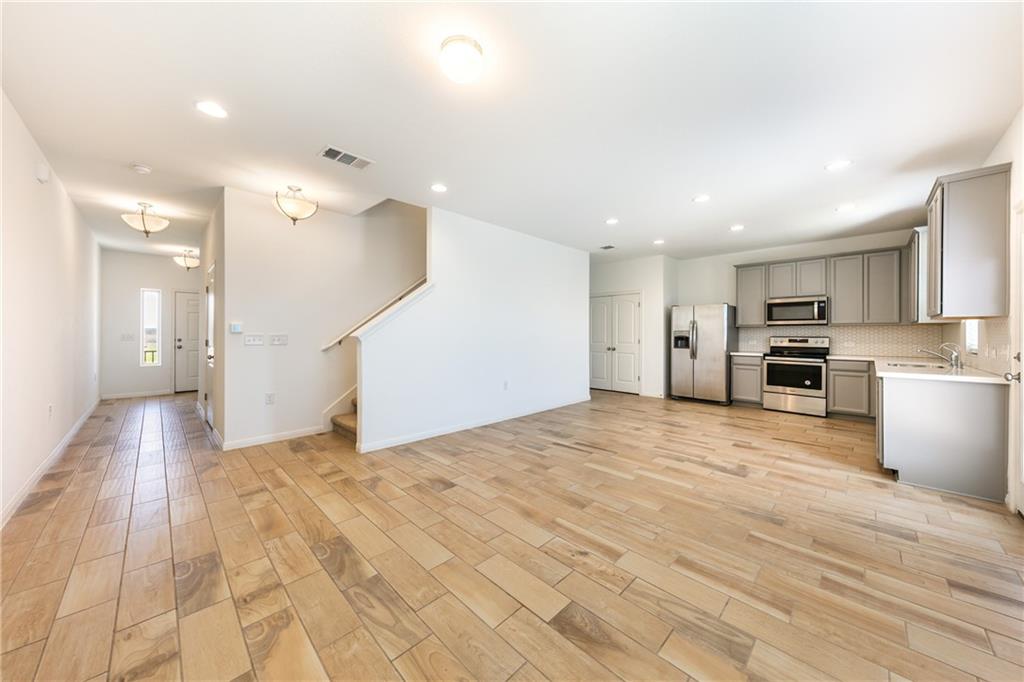 6708 Routenburn Street Austin, TX 78754 - Photo 3 of 21 a view of a kitchen with a sink and a refrigerator