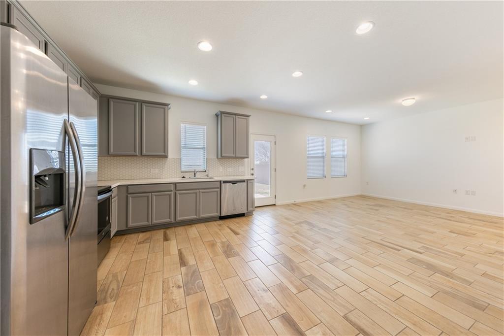 6708 Routenburn Street Austin, TX 78754 - Photo 4 of 21 a kitchen with stainless steel appliances a refrigerator sink and cabinets