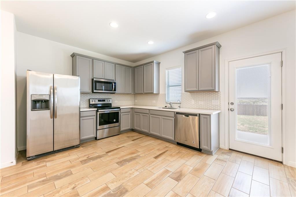 6708 Routenburn Street Austin, TX 78754 - Photo 5 of 21 a kitchen with a refrigerator sink and cabinets