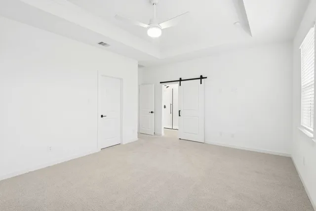 an empty room with an entryway and window