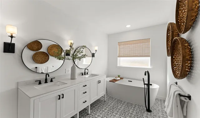 a bathroom with a double vanity sink mirror and bathtub