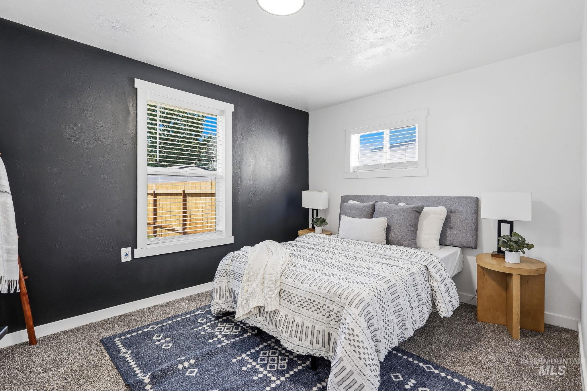 2152 Artesian Road Eagle, ID 83616 - Photo 24 of 50 Room featuring a dark accent wall, white walls, and a light gray carpet