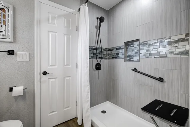 a bathroom with a toilet a sink and a mirror