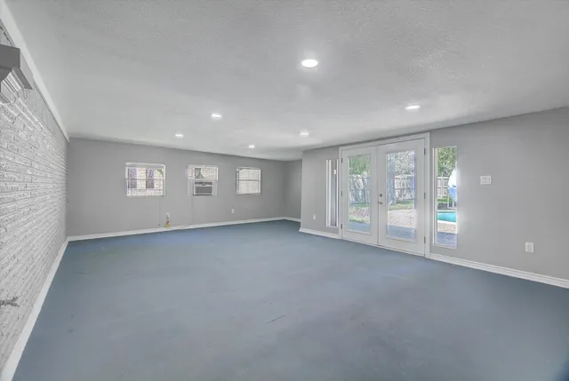 an empty room with windows and closet