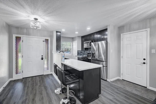 a bathroom with a granite countertop sink a vanity and a large mirror
