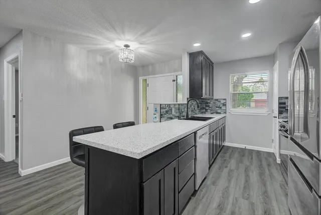 a kitchen with stainless steel appliances a stove sink and microwave
