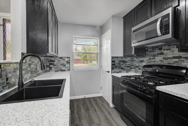a kitchen with sink and cabinets