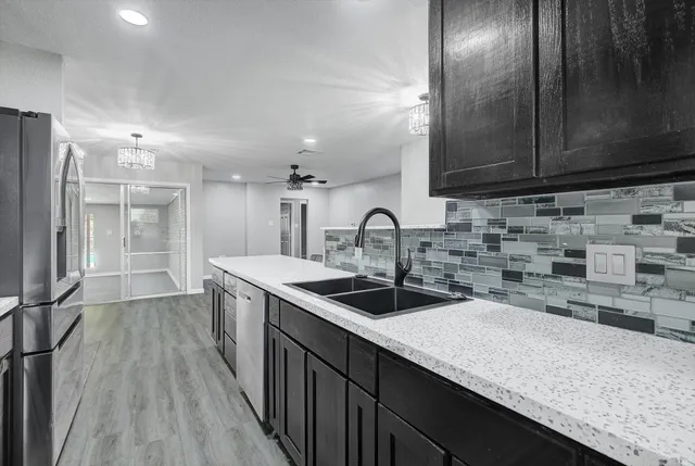 a kitchen with stainless steel appliances granite countertop a stove microwave and cabinets