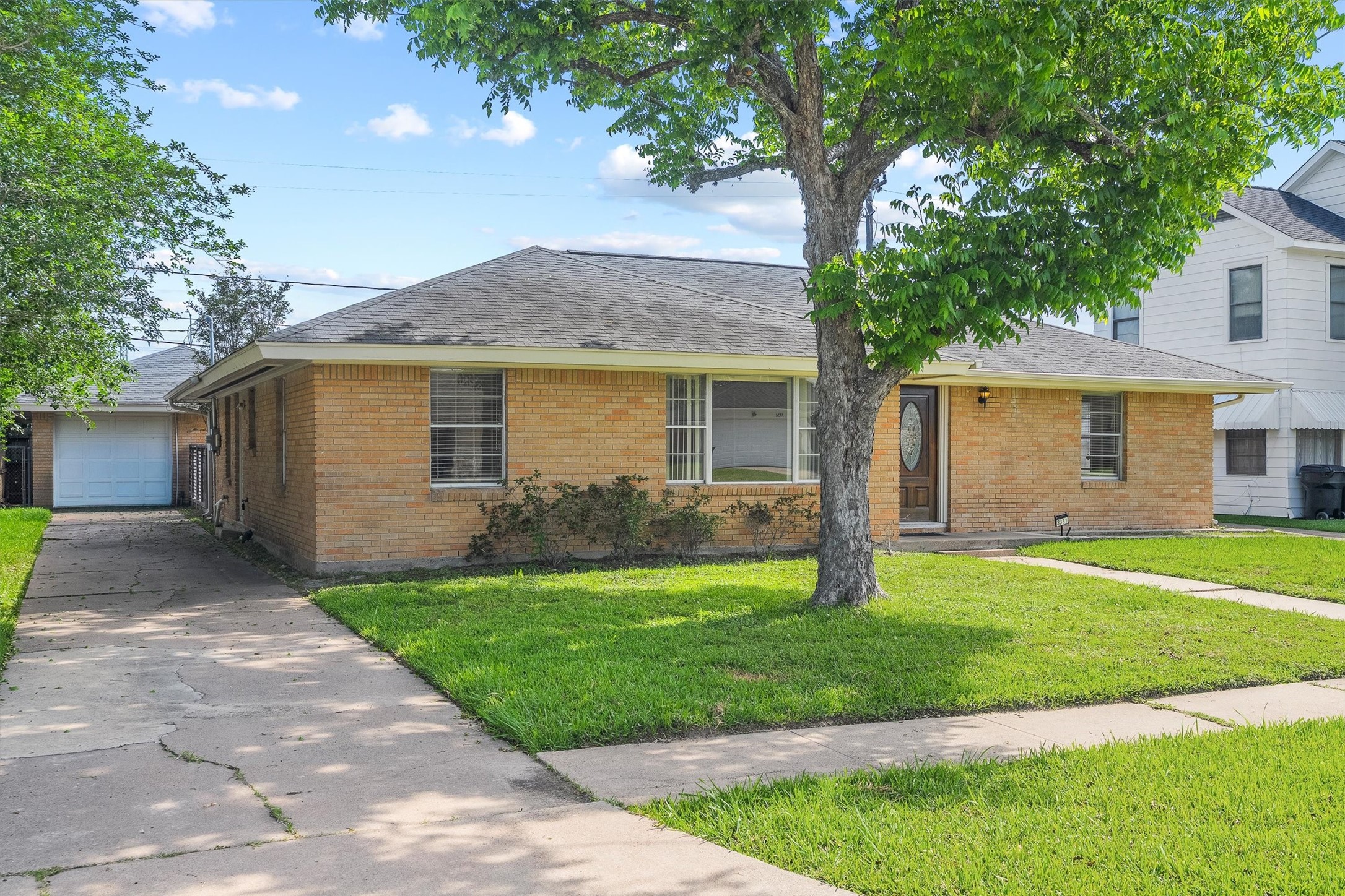 3331 Arbor Street Houston, TX 77004 - Photo 1 of 30 This charming single-story brick home features a welcoming front yard with a large tree, a long driveway leading to a detached garage, and a classic front door with a decorative glass insert. Perfect for those seeking a cozy, suburban feel.
