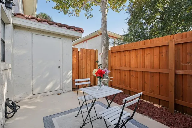 a outdoor space with a table and chairs