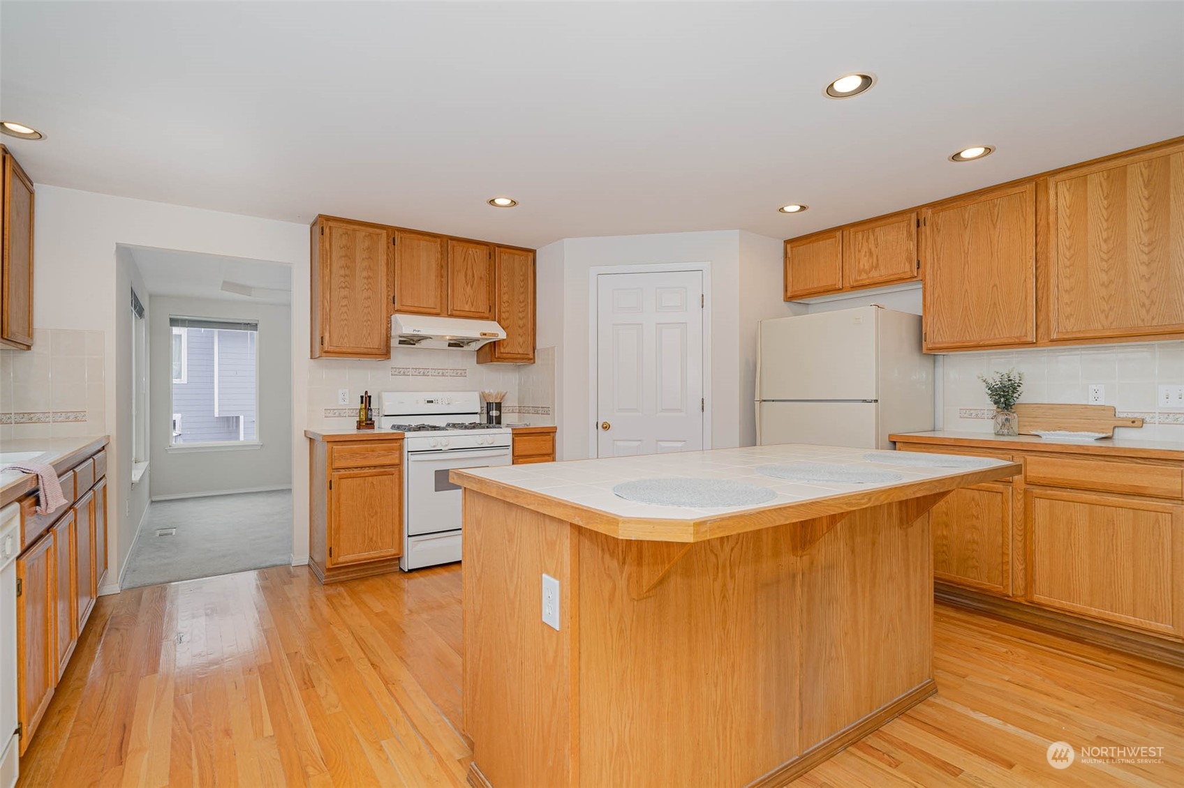 14539 144th Place Southeast Renton, WA 98059 - Photo 11 of 37 a kitchen with a sink a stove top oven a counter space and cabinets